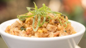 a bowl of rice with green garnish