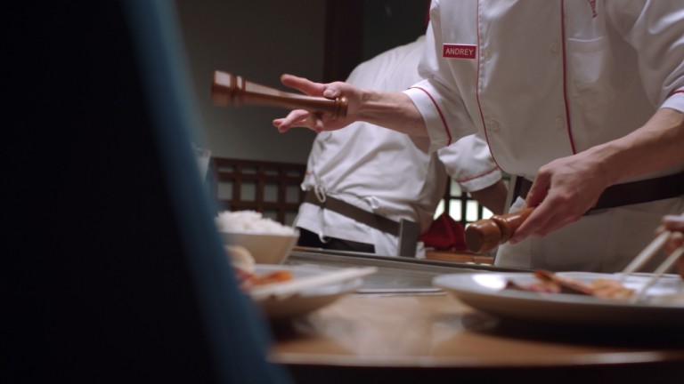 a chef cooking a holding a pepper grinder