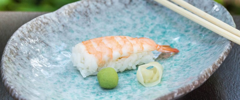 a plate of food with a fork and a piece of rice