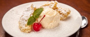 a plate of food with a cherry and ice cream