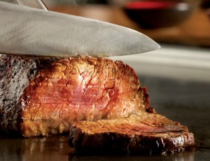 a knife cutting a piece of meat