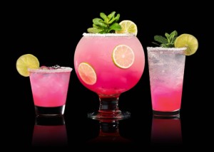 a group of glasses with pink drinks